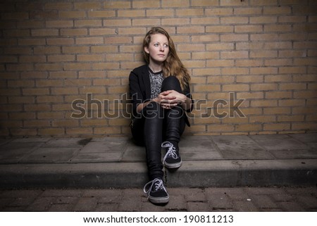 Beautiful woman against brick wall