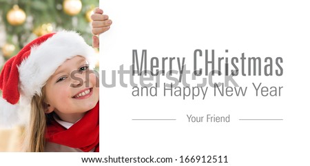 Pretty blond hair girl with santa hat and red comforter holding white board with space for text isolated on white. Christmas tree in background