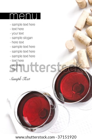 Winery menu project. Two glasses of red wine, corks on white table cloth. Space for text isolated on white.