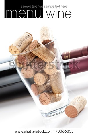 Wine corks in glass jar. Two botles of wine in background. All on white background