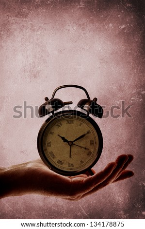 Alarm clock sitting in palm of hand