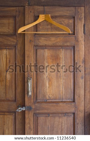 Wooden hanger on door of antique closet