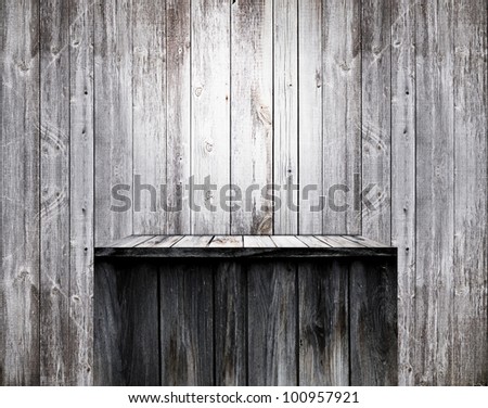 Empty wood shelf on old wall