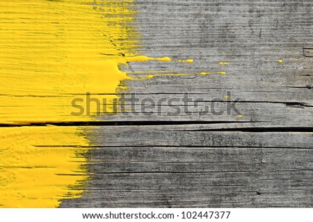 yellow paint on old wooden background