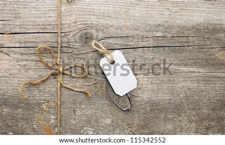 String tied in a bow and address label attached. With copy space