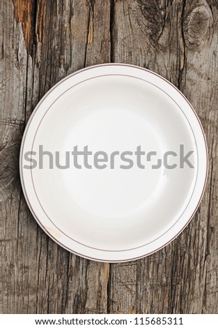 single white plate on old wood background