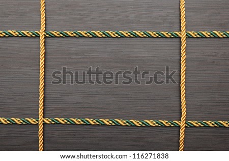 colorful rope frame on wooden background
