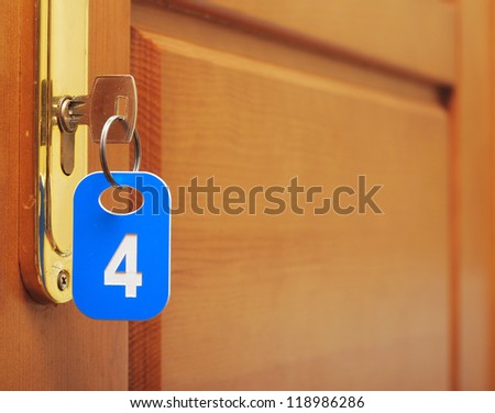 Door wood and key in keyhole with numbered label