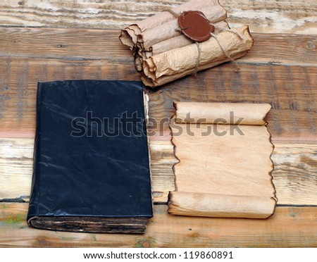Scrolls of vintage paper with old book
