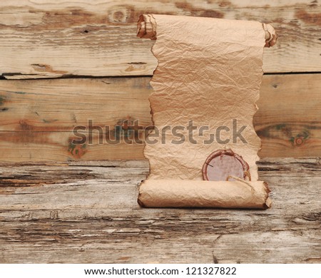 Ancient scroll with wax seal on wooden table