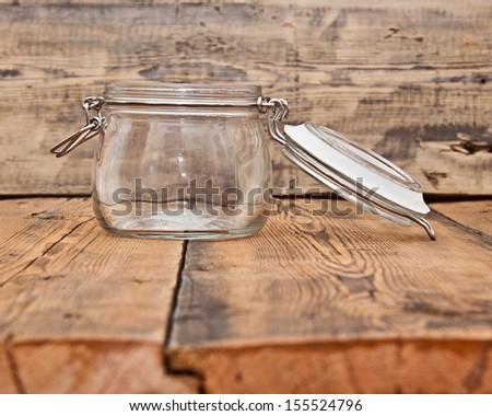 an empty glass jar on old wooden table