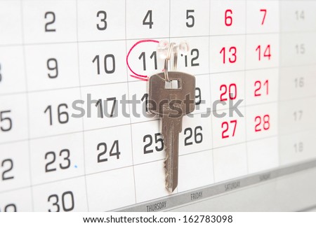 A house key on a calendar background, paying your mortgage on time