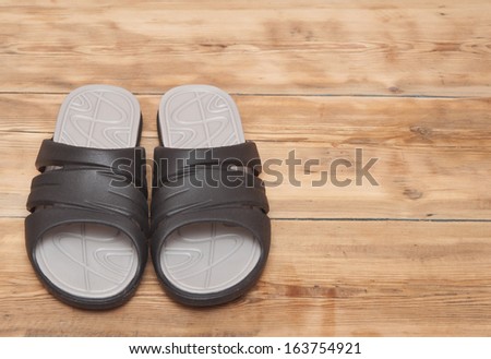 black flip flops on wooden deck. summer background
