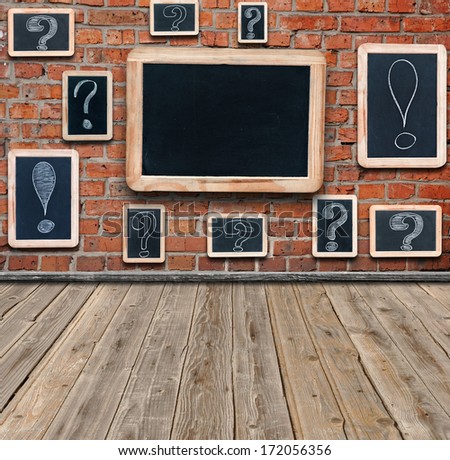 Question marks and exclamation marks white chalk drawing on small blackboard hanging in old room and large chalkboard with copy space for your text