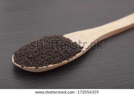 Bamboo spoon with black leaf tea