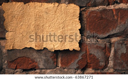 vintage old paper on old brick wall
