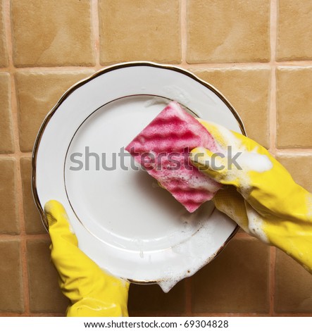 close up of a person washing a plate