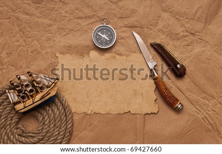old paper, rope coil, compass, decorative knife and model classic boat