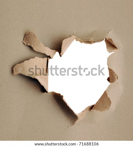 Torn paper - gray cardboard ripped apart showing underlying layer