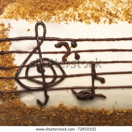 appetizing cake with treble clef drawing by cream