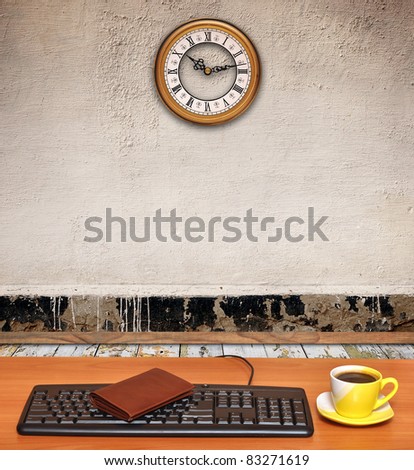 room interior-keyboard on desk and a business clock on old wall