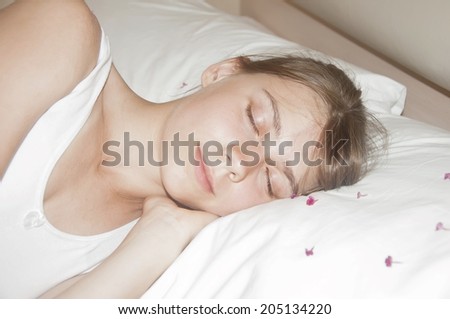 Attractive young woman sleeping in bed