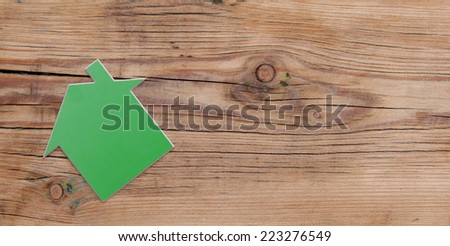 House shaped sign on rustic wood background