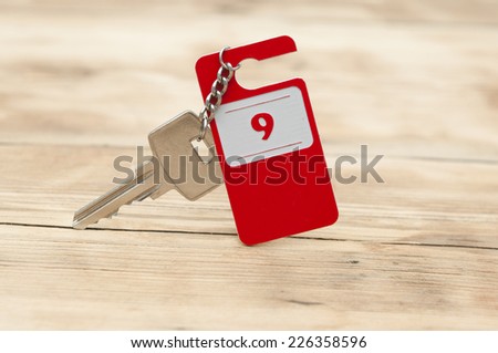 Hotel suite key with room number 9 on wood table