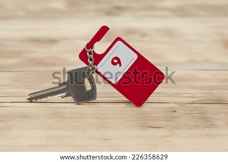 Hotel suite key with room number 9 on wood table