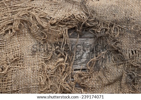 background of burlap with a hole for writing text. texture of the wood