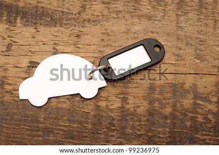 model car with blank tag on wooden background. space for your text