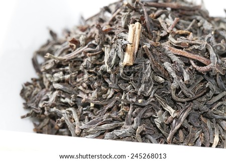 close up of black tea leaves with bergamot orange zest