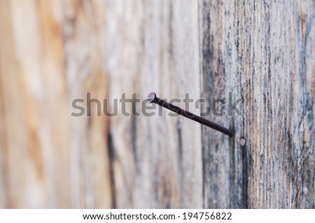rusty nail in an old piece of wood