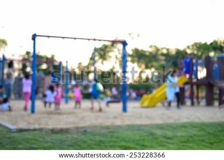 Colorful playground with children and parents in park (blur background)