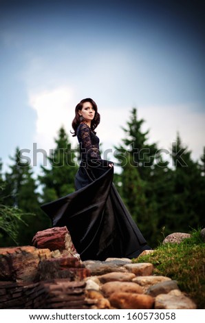 Mysterious girl in black lace dress from fairytale