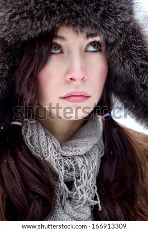 Face of brunette hair woman in fur hat