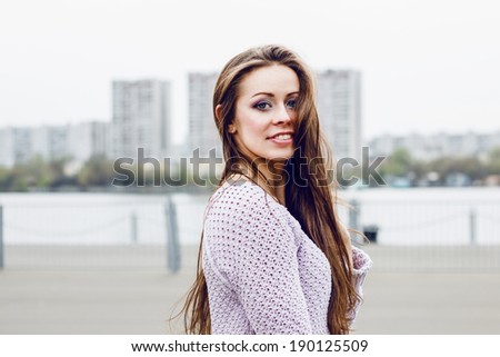Portrait of happy beautiful smiling woman on urban background