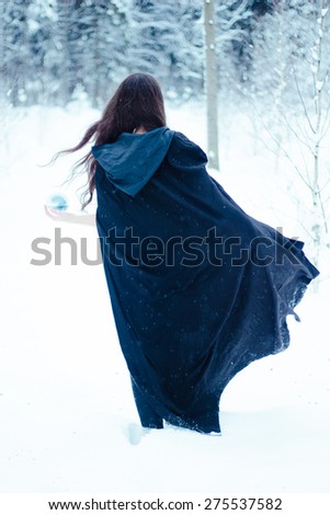 Witch in black cloak with magi? ball