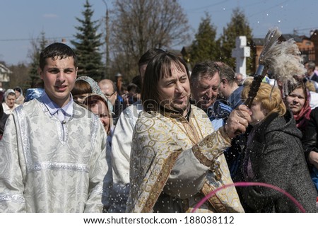 DARNA VILLAGE, ISTRA RAYON, RUSSIA, 2014, APRIL, 19: Orthodox priest father Constantin Volkov with his congregation during ceremony of consecration of Easter eggs and cakes for Easter Christ\'s