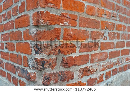 Abstract of a weathered brick wall corner on a building.