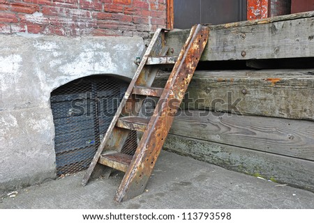 Close up of a old weathered set of steps allowing access to the loading dock from the street level.