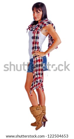 Beautiful woman wearing scarf and blue jean skirt standing with her hands on her hips.