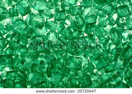 - macro of tiny green twinkles/crystals (cake decor) - backlight