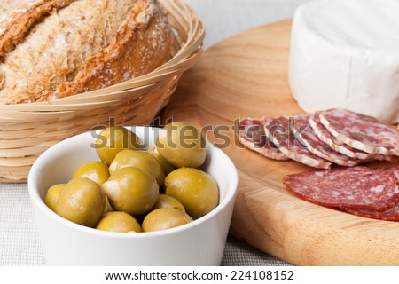 Green olives stuffed with almonds, bread, sausages and french cheese.