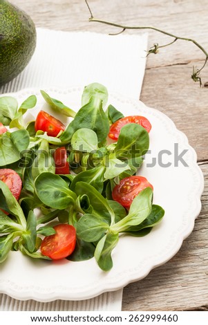 Salad with corn salad and cherry tomatoes.