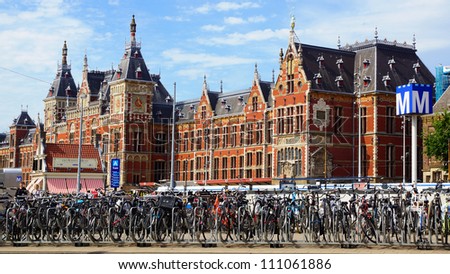 AMSTERDAM, HOLLAND - AUGUST 01: Amsterdam Central station. Holland. August 01, 2012 Amsterdam, Holland. Many bicycles parked in front of the Central station.
