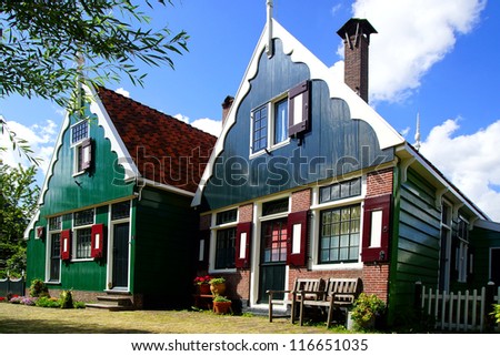 ZAANDAM, Holland - JULY 30: Typical Dutch houses. Zaanse Schans is a museum village with dutch houses and wind mills. In most of the mills still live people; July 30, 2012 in Zaandam, Holland
