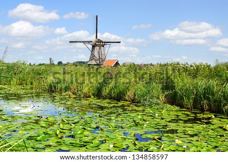 KINDERDIJK, HOLLAND - AUGUST 03: Windmill. In most of the mills in Kinderdijk still live people on August 03, 2012 in Kinderdijk, Holland. Windmills have been a UNESCO World Heritage Site since 1997