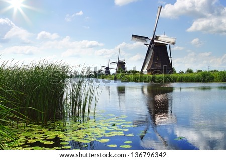 KINDERDIJK, HOLLAND - AUGUST 03: Windmill. In most of the mills in Kinderdijk still live people on August 03, 2012 in Kinderdijk, Holland. Windmills have been a UNESCO World Heritage Site since 1997