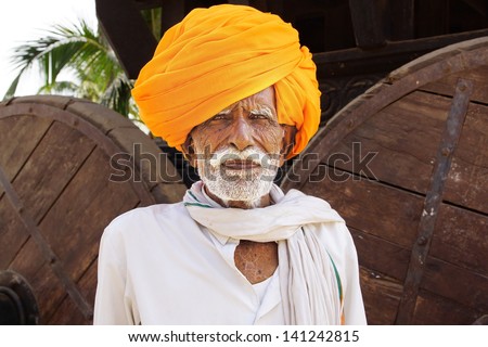 HAMPI, INDIA - FEBRUARY 01: Portrait of an old man in a traditional turban on the street of the city on February 01, 2012 in Hampi, India. Turbans reflect culture, profession of person.
